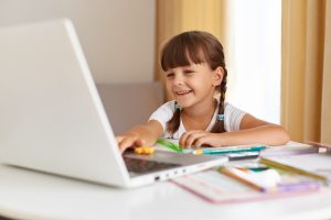 indoor-shot-happy-positive-dark-haired-schoolchild-posing-home-looking-portable-computer-with-charming-smile-distance-education-having-online-lesson_176532-15158