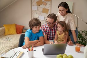 young-happy-family-working-laptop-together-parents-helping-children-with-homework-studying