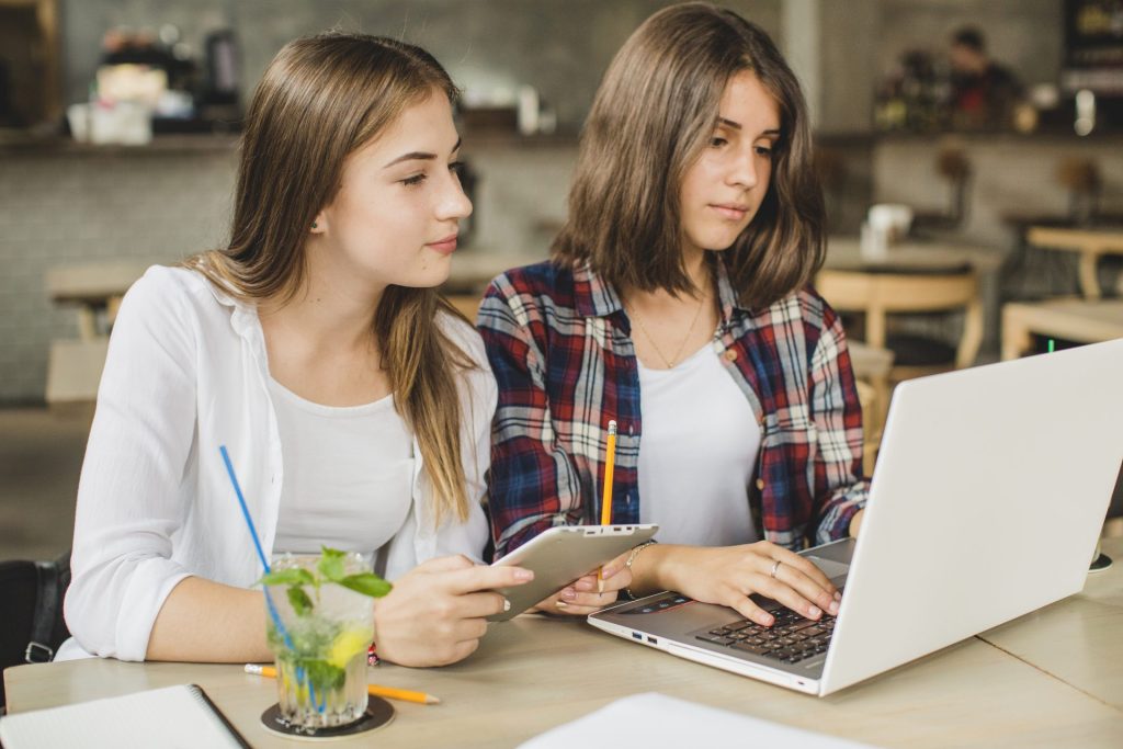 two girls studying on a laptop